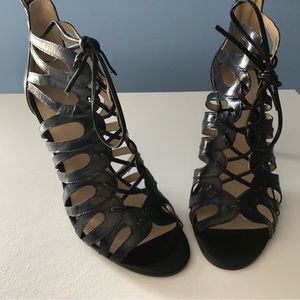 Black high heels with front tie strap.